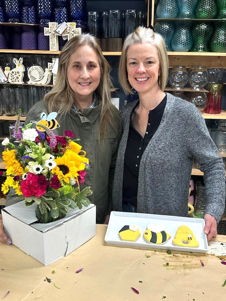 Group holding decorated cookie boxes.