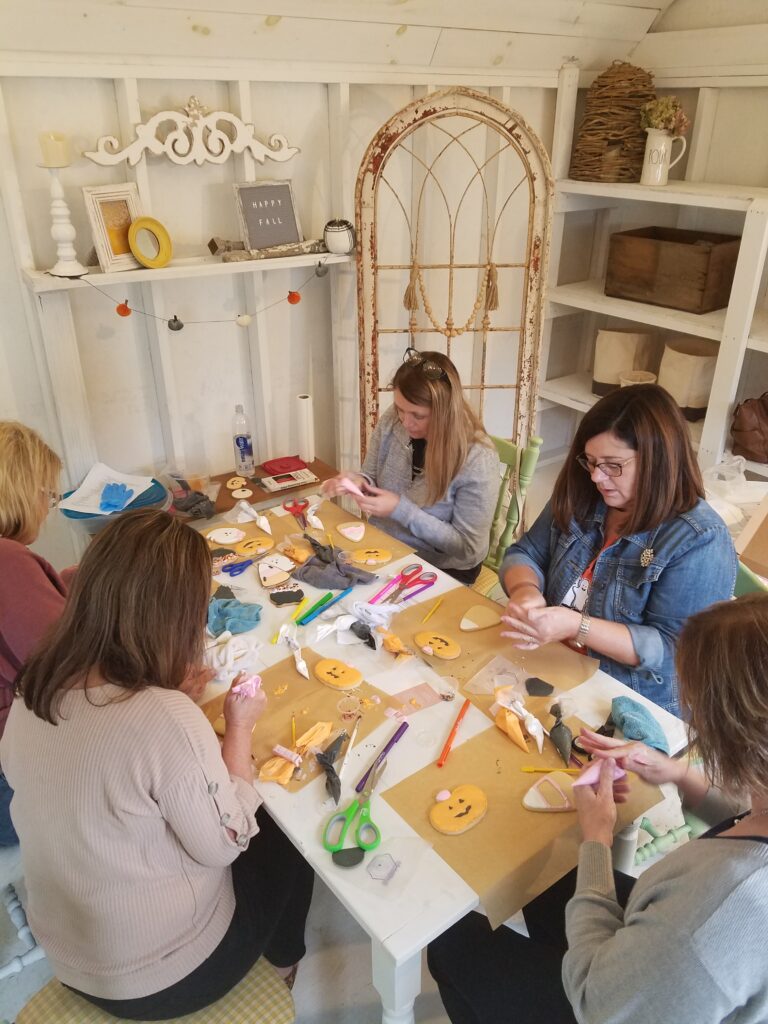 People decorating cookies at a table.