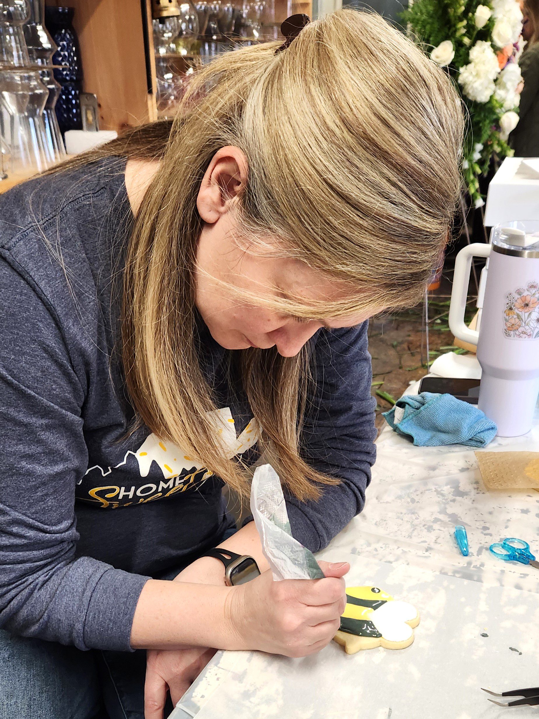 People decorating cookies at a table.